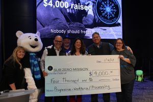 Progressive employees present check to sub zero mission board