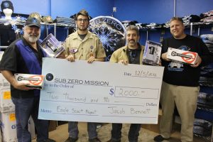 Jacob Bennett presents the check the went towards the purchase of equipment